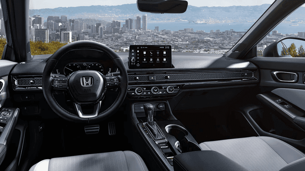 2026 Honda Civic Sedan interior dashboard with Honda steering wheel and touchscreen overlooking a city near Hauppauge NY