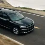Black 2026 Honda Prologue electric SUV driving along a coastal highway, a top pick for EV buyers near Hauppauge NY