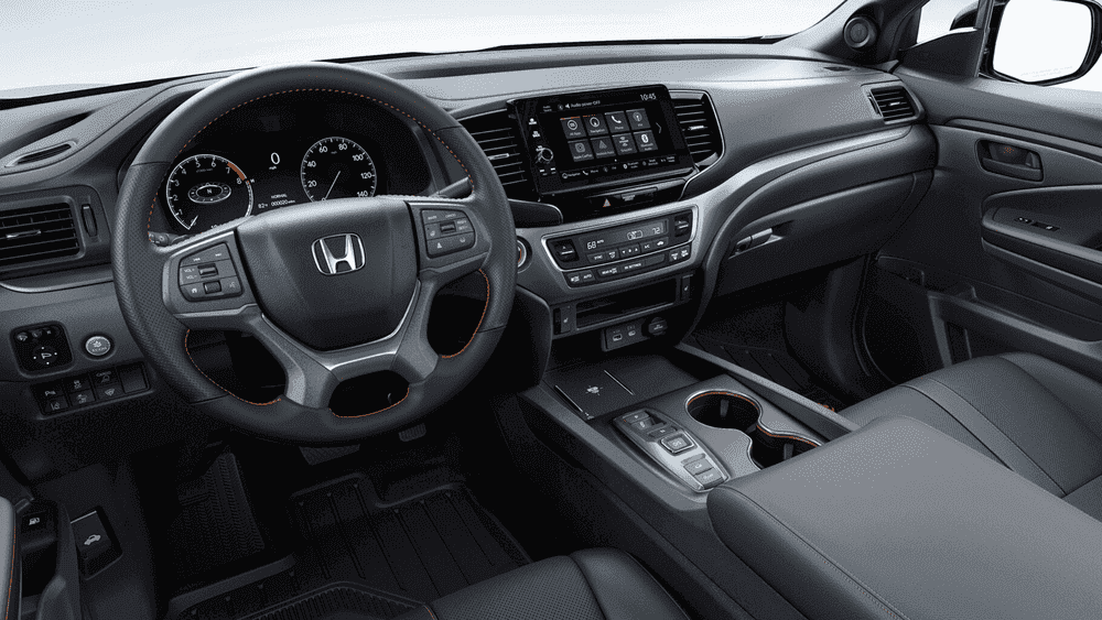 2026 Honda Ridgeline interior dashboard with Honda steering wheel, touchscreen, and orange accent stitching near Hauppauge NY