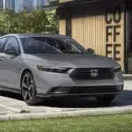 Silver 2026 Honda Accord parked outside a modern coffee shop, blending refined style with everyday comfort near Hauppauge NY