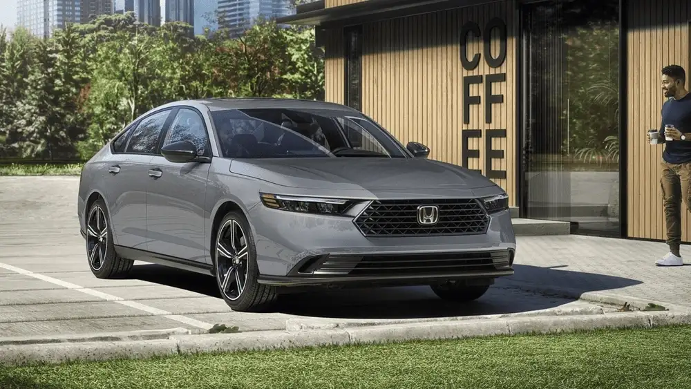 Silver 2026 Honda Accord parked outside a modern coffee shop, blending refined style with everyday comfort near Hauppauge NY