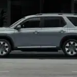 Silver 2026 Honda Pilot in full side profile parked on a city street, ready for road trip season near Hauppauge NY