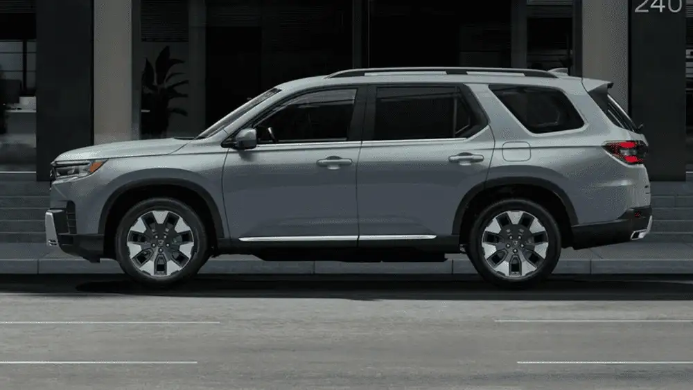 Silver 2026 Honda Pilot in full side profile parked on a city street, ready for road trip season near Hauppauge NY