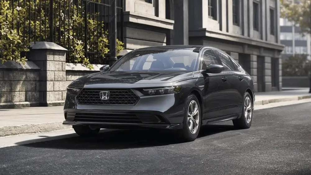 Dark gray 2026 Honda Accord Hybrid near Hauppauge, NY, parked on a city street.