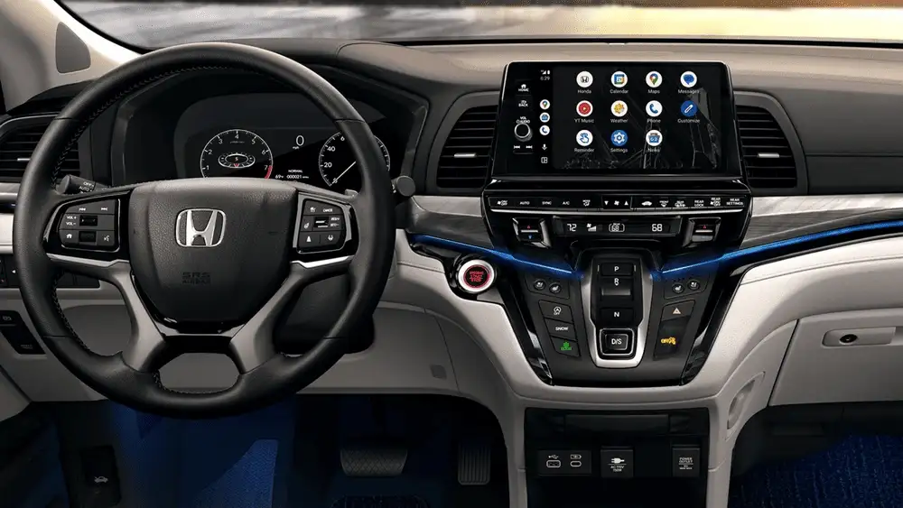 Black interior of a 2026 Honda Odyssey near Hauppauge, NY, showing the steering wheel and touchscreen display.