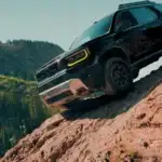 Black 2026 Honda Passport near Hauppauge, NY, climbing a rocky trail in a mountain forest.