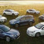 Assorted Subaru vehicles parked in a cluster in a field