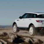 white 2019 range rover evoque on a dirt road