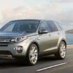 2019 Land Rover Discovery Sport in gray driving on coastal highway