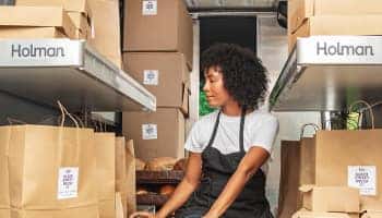A graphic of a woman standing in front a partition in a commercial vehicle
