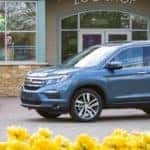 2018 Honda Pilot Elite parked near flowers