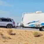 Silver 2019 Honda Passport towing white trailer in desert