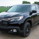 Black 2020 Honda Ridgeline towing trailer with smaller vehicle