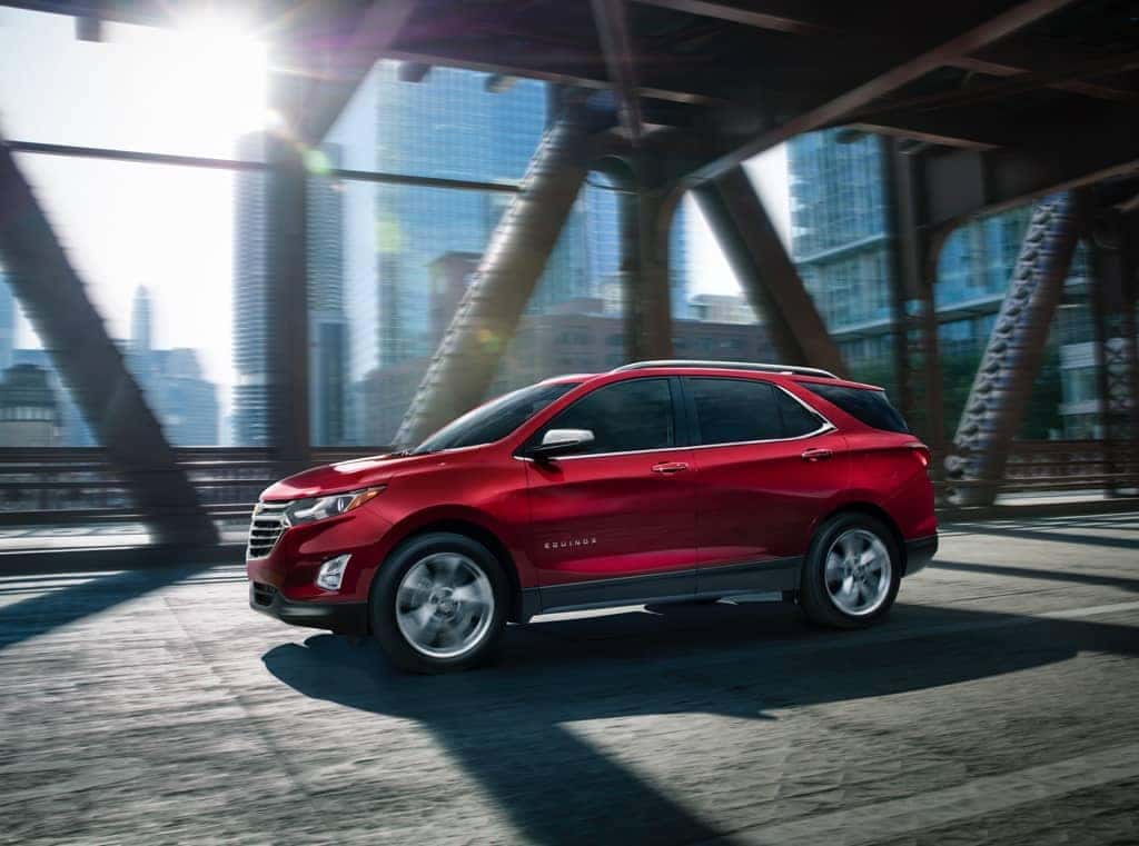 Red Chevy Equinox on city bridge
