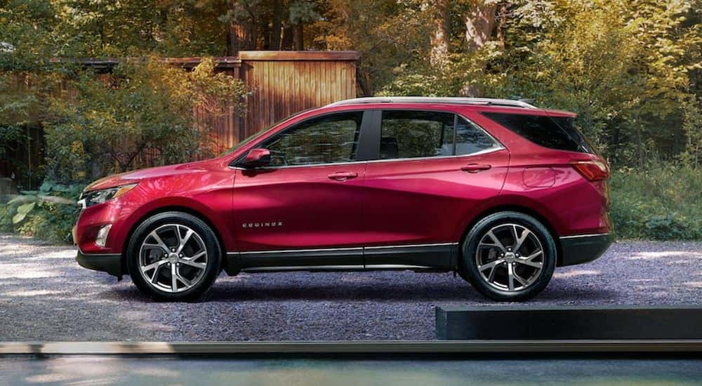 A red 2021 Chevy Equinox is parked in a driveway.