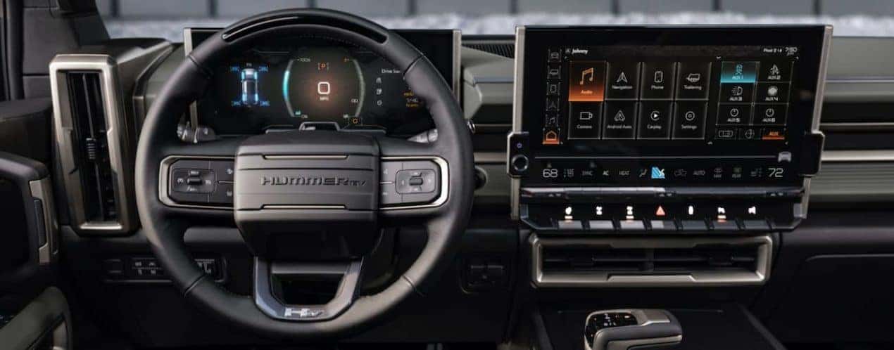 The infotainment screens and wheel are shown in a 2023 GMC Hummer EV SUV.