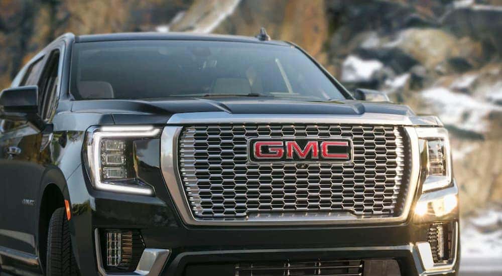 A black 2021 GMC Yukon Denali is shown parked in the mountains.