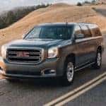 A grey 2020 GMC Yukon is shown driving on an open road after leaving a Murfreesboro used car dealer.