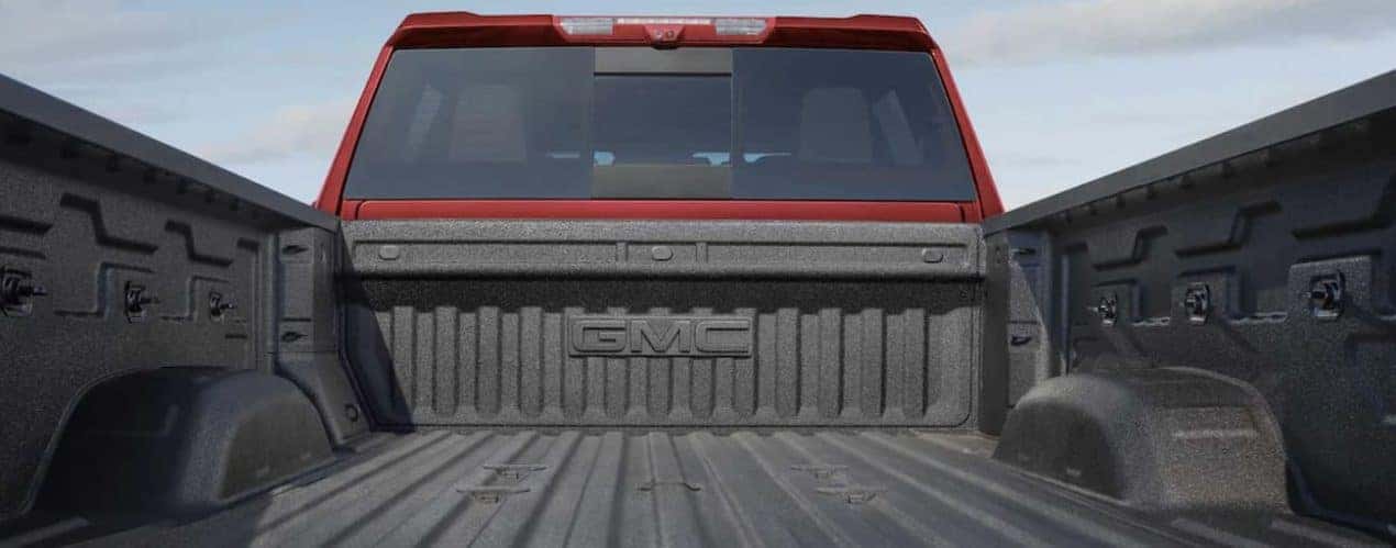 The bed of a red 2022 GMC Sierra 2500HD is shown in close up.