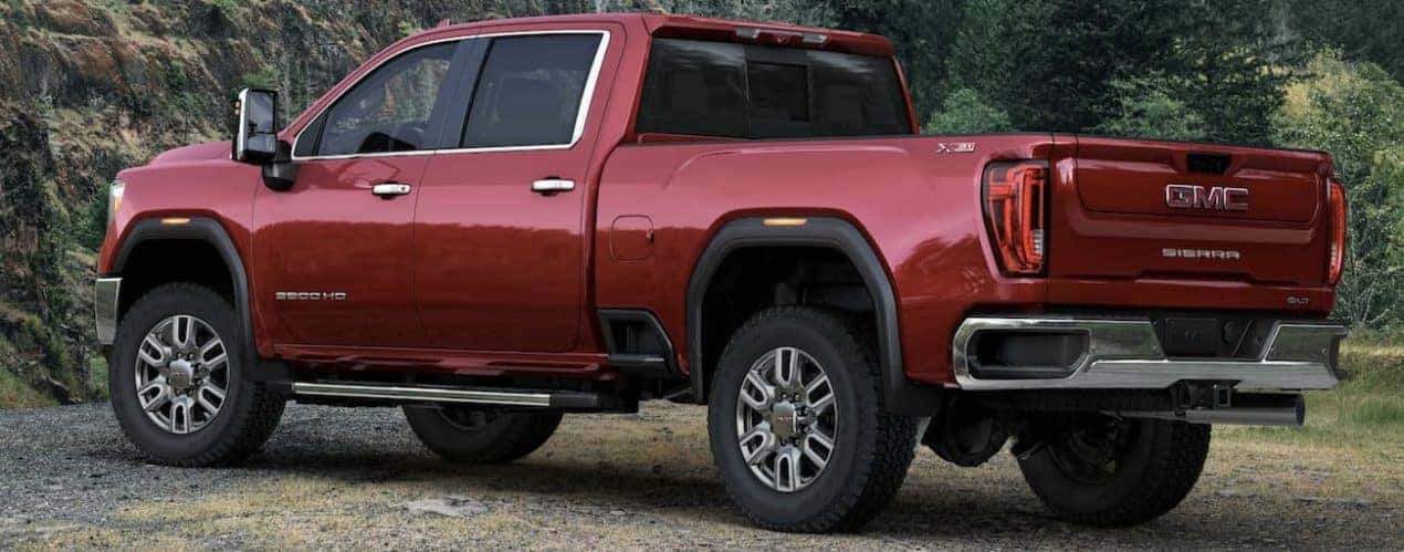 A red 2022 GMC Sierra 2500HD is shown from the side after winning a 2022 GMC Sierra 2500HD vs 2022 Ford F-250 comparison.