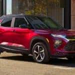 A red 2022 Chevy Trailblazer RS is shown parked on the side of a city street.