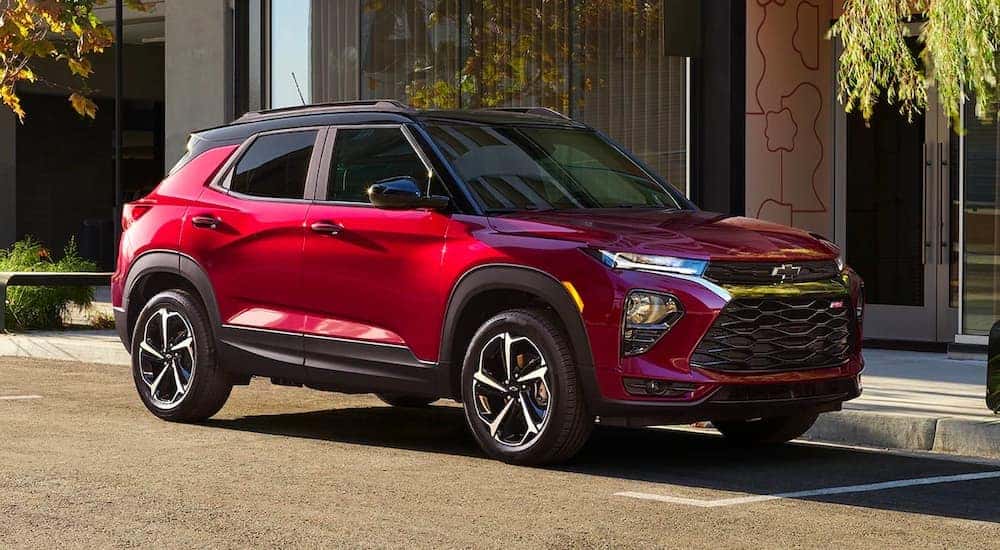 A red 2021 Chevy Trailblazer RS is shown parked on the side of a city street.