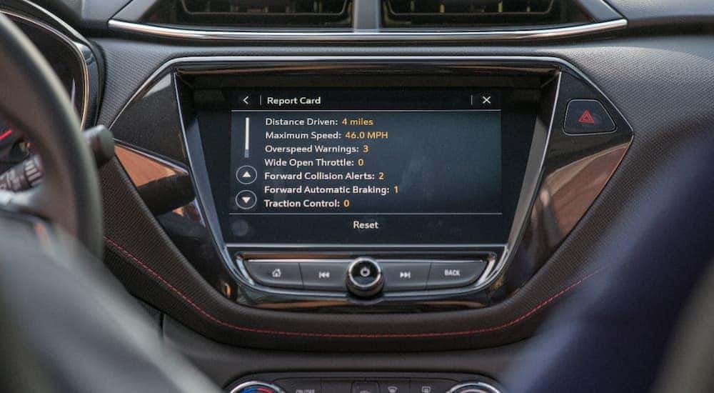 A close up shows the Chevy teen driver technology report card on the infotainment screen.