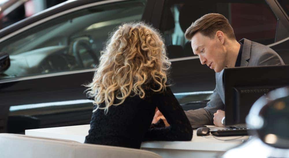 A salesman is shown speaking to a customer about a Chevy pre-order.