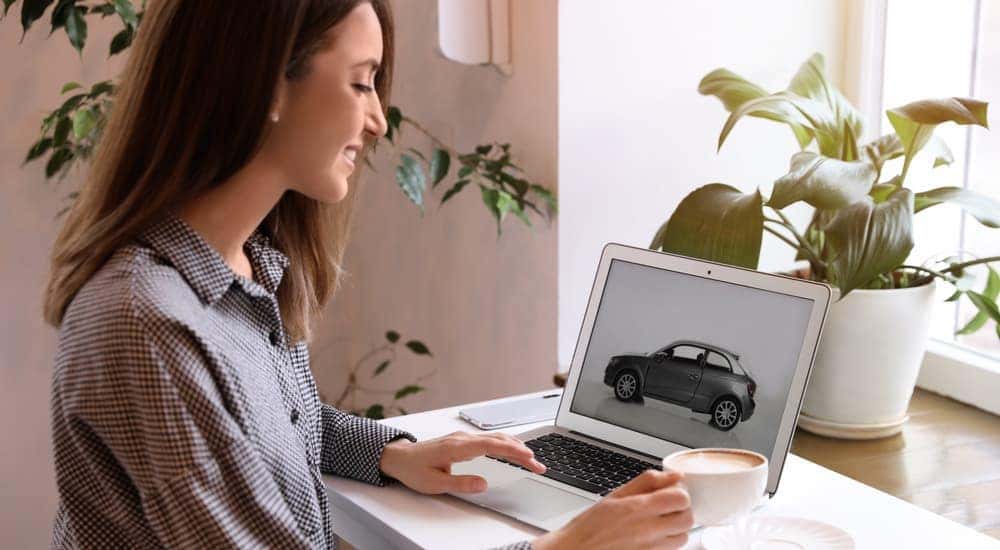 A woman is shown researching a Chevy pre-order online.