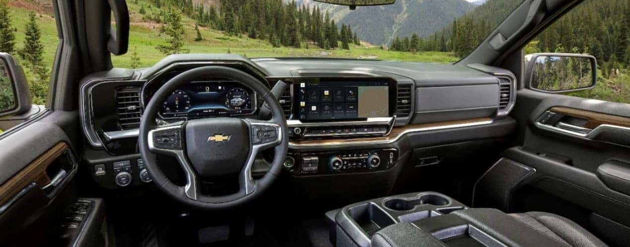 The black interior of a 2022 Chevy Silverado 1500 shows the steering wheel and center console.