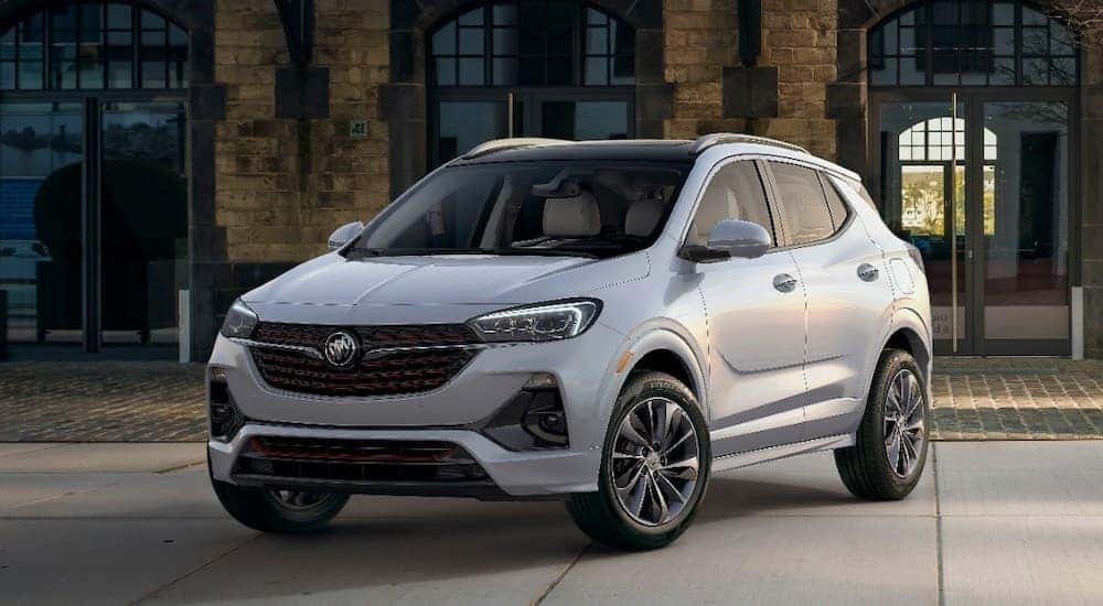 A white 2020 Buick Encore is shown from the front at an angle on a city street.