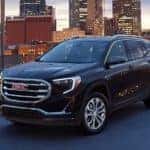 A black 2020 GMC Terrain SLE is shown parked on a city rooftop after leaving a Murfreesboro used car dealer.