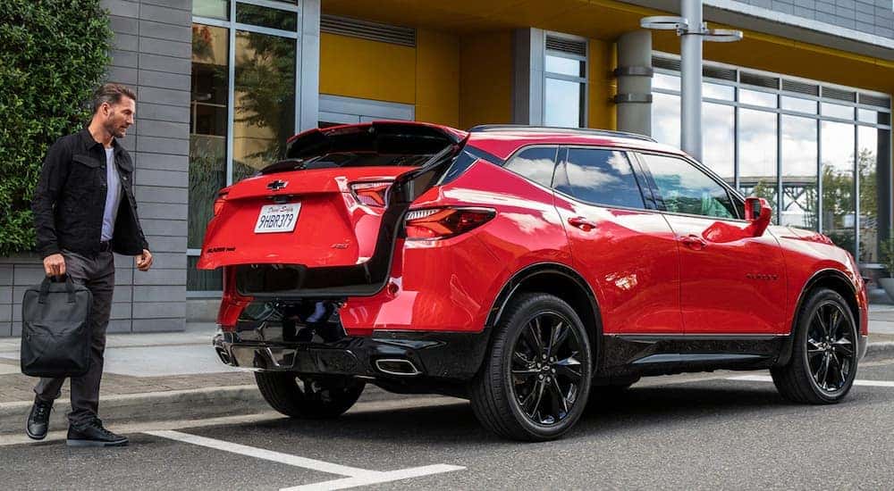 A red 2020 Chevy Blazer RS is shown from the rear on a city street.