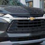 A black 2022 Chevy Blazer is shown parked near a Shelbyville used car dealership.