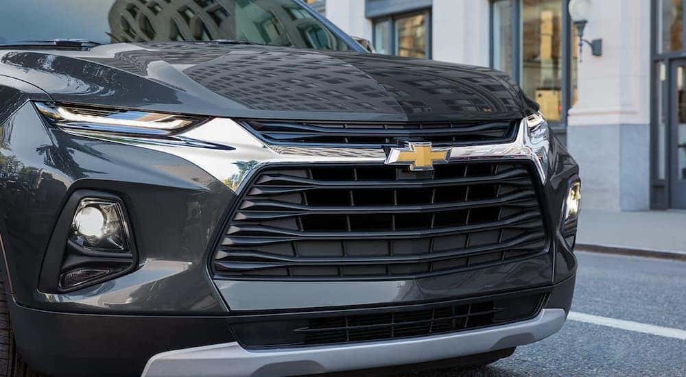 A black 2022 Chevy Blazer is shown parked near a Shelbyville used car dealership.