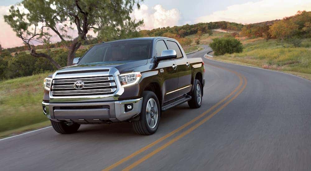 A black 2019 Toyota Tundra is shown driving on an open road.