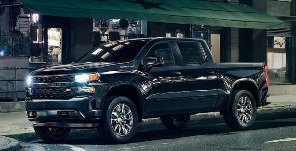 A popular certified Chevrolet for sale, a black 2021 Chevy Silverado 1500, is shown from the side.