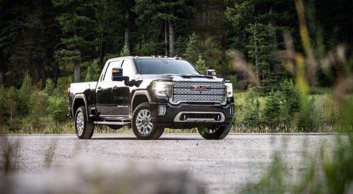 A black 2020 GMC Sierra 2500HD Denali is shown parked on an empty lot after leaving a certified used truck dealer.