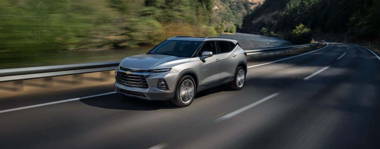 A silver 2022 Chevy Blazer is shown driving on an open road.