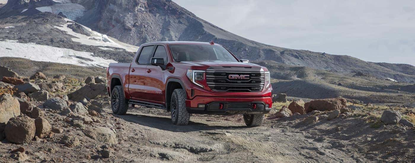 A red 2022 GMC Sierra 1500 AT4x is shown from the front at an angle after leaving a GMC Sierra dealer..
