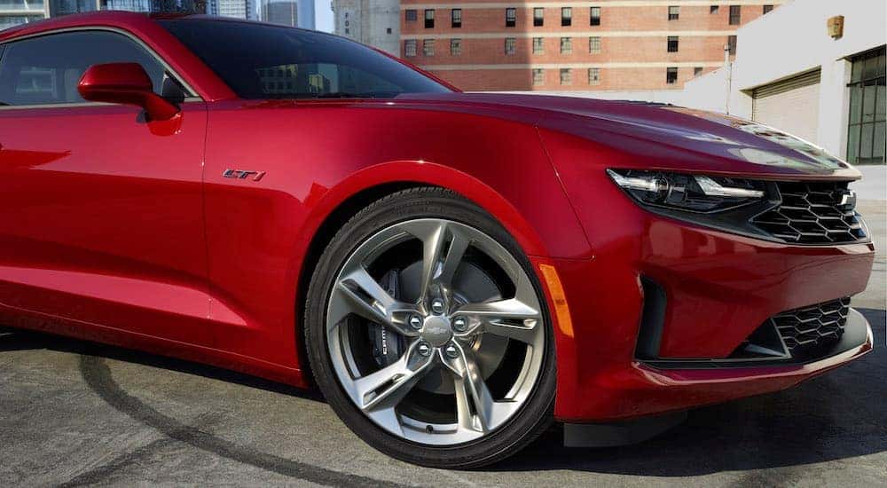A close up of a chrome rim on a red 2023 Chevy Camaro LT1.