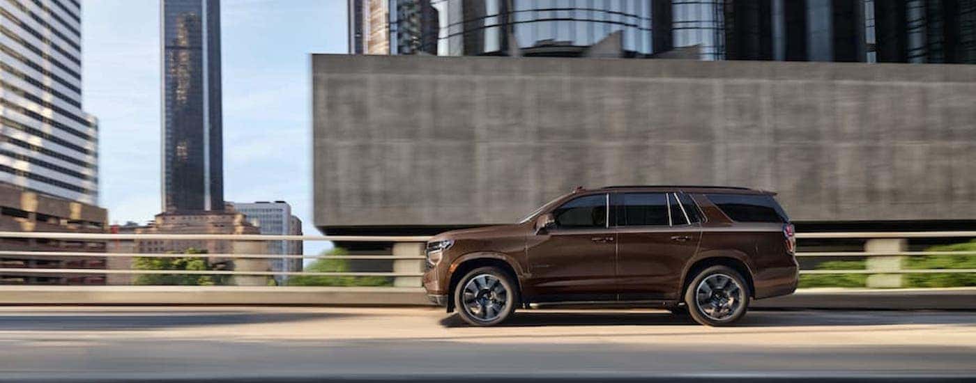 A brown 2022 Chevy Tahoe RST is shown from the side.
