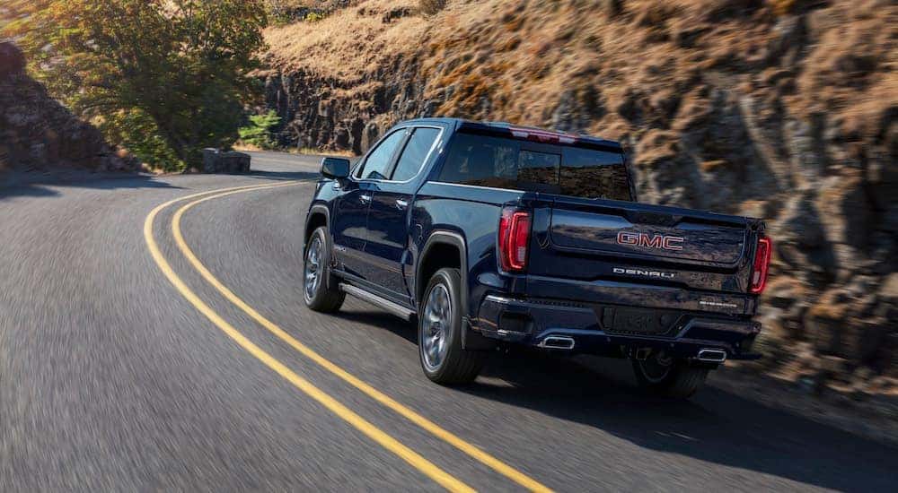 A blue 2023 GMC Sierra 1500 Denali is shown from the rear at an angle after leaving a Tullahoma GMC dealer.