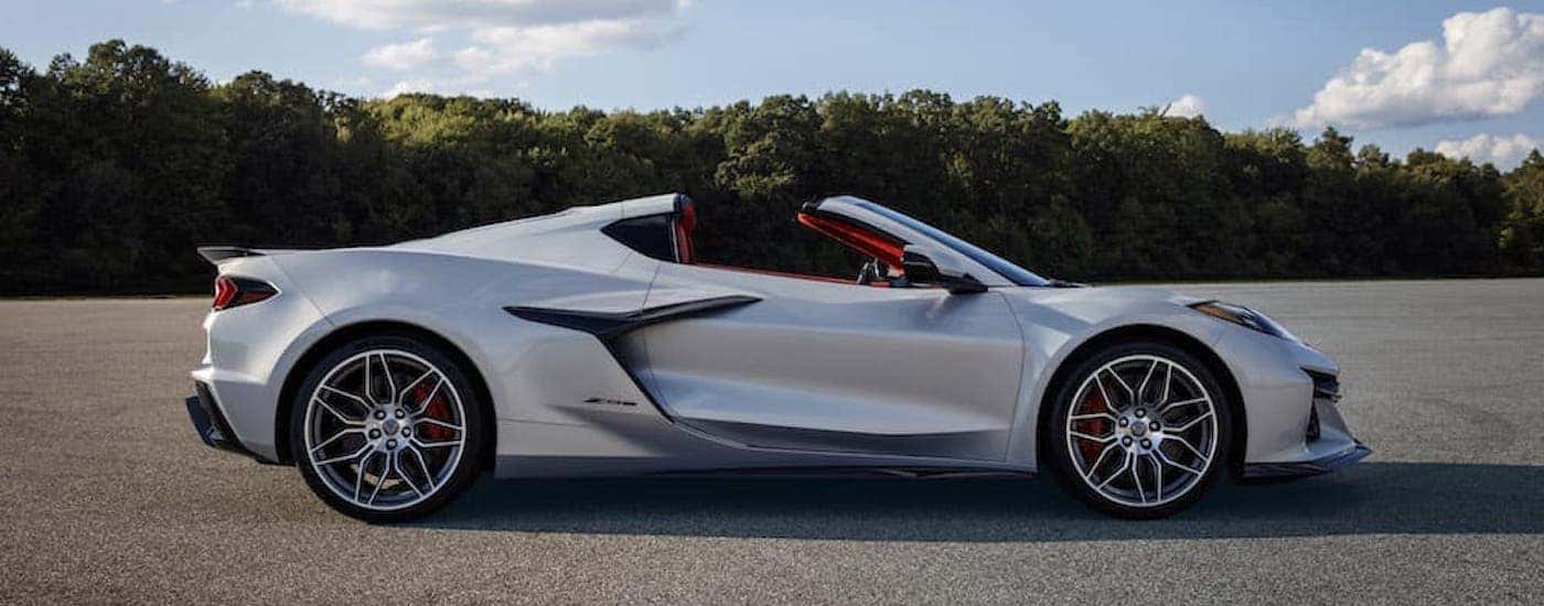 A silver 2023 Chevy Corvette Z06 is shown from the side.