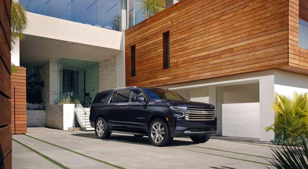 A dark blue 2022 Chevy Suburban is shown parked in a driveway.