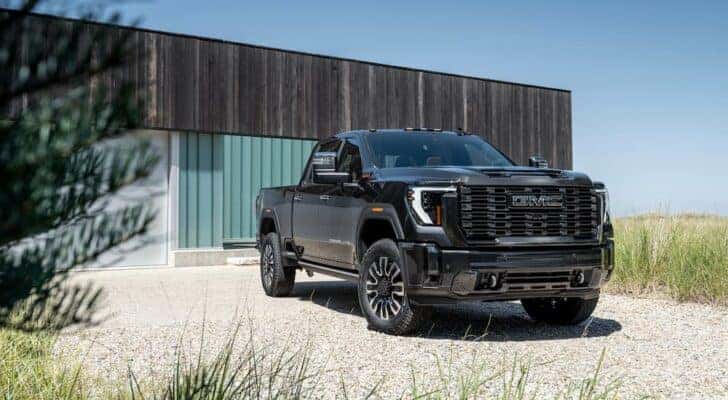 A black 2024 GMC Sierra 2500 HD Denali Ultimate is shown from the front at an angle after leaving a Lewisburg, TN GMC dealer.