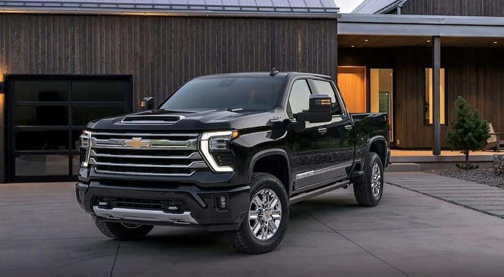 A black 2024 Chevy Silverado 1500 High Country is shown parked on a driveway after visiting a Lewisburg, TN, Chevy dealer.