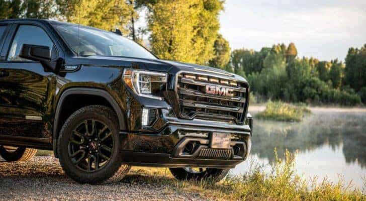 A close up shows the front end of a black 2020 GMC Sierra 1500 SLE Elevation.