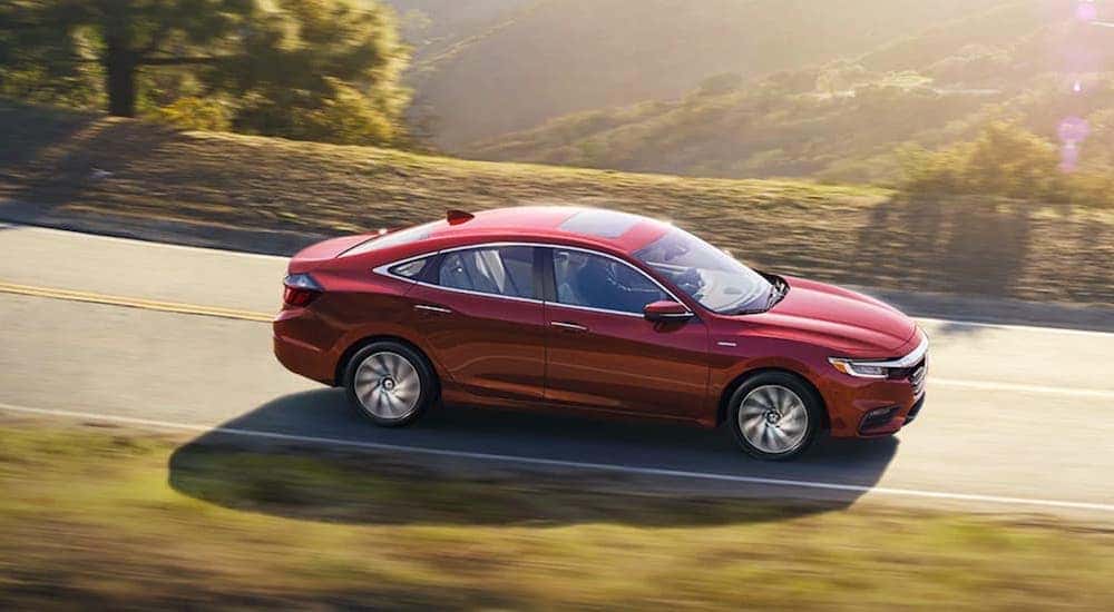 A red 2020 Honda Insight is shown from the side after the owner searched for ways to "sell my car".