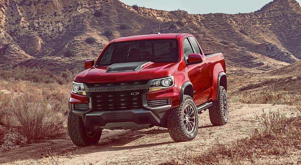 A red 2021 Chevy Colorado ZR2 is shown from the front at an angle after leaving a used truck dealership near me.